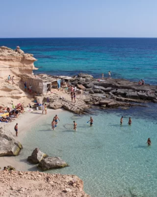 Where turquoise waters meet timeless traditions 🌊Hidden along Ibiza’s coastline, coves like this have sheltered generations of fishermen — their weathered huts still standing as reminders of a slower, simpler way of life.Today, they share the same waters with sunseekers and swimmers, blending the island’s heritage with its easygoing Mediterranean spirit. Life here isn’t rushed — it’s lived to the rhythm of the waves 💙